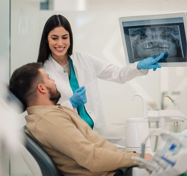 Dentist showing a patient an x-ray of their teeth