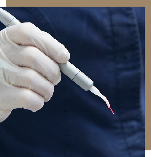 Dentist holding a laser pen