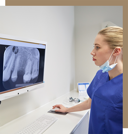 Dentist looking at an x-ray of a patient's teeth