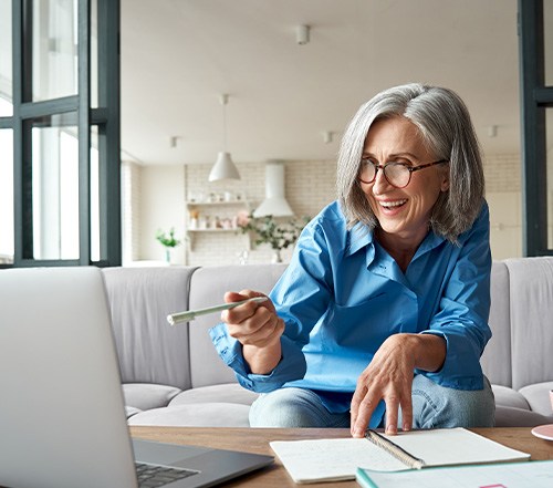 Dentures patient in Cocoa Beach smiling while budgeting