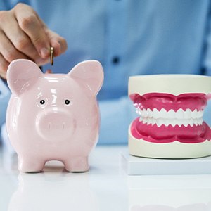 Dentures patient in Cocoa Beach with piggy bank