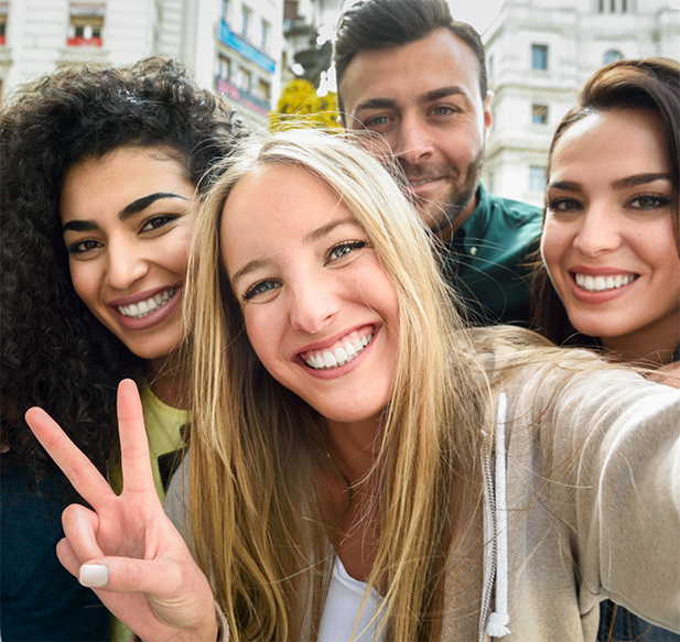 Selfie of four adults on a downtown city street