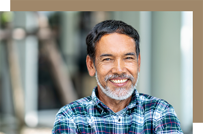 Smiling man in a blue plaid shirt