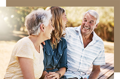 Woman laughing with her parents in a park