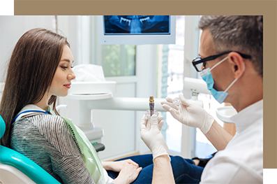 Dentist showing a dental implant to a patient