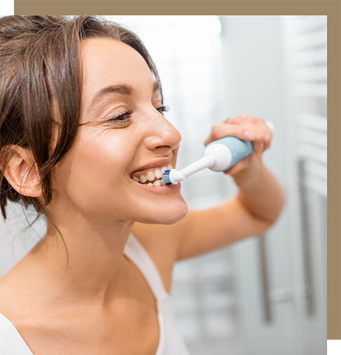 Woman brushing her teeth at home