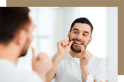 Young man flossing his teeth at home