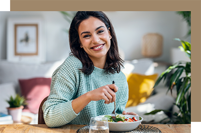 Woman eating a bowl of salad