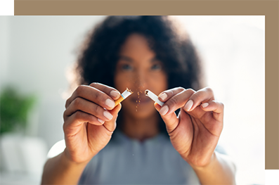 Woman breaking a cigarette in half