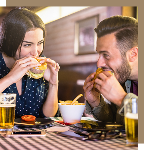 Man and woman eating burgers