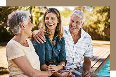 Woman sitting outdoors with her parents
