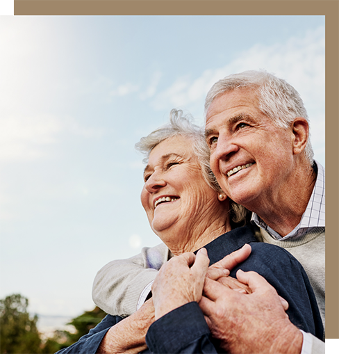 Senior couple hugging outdoors