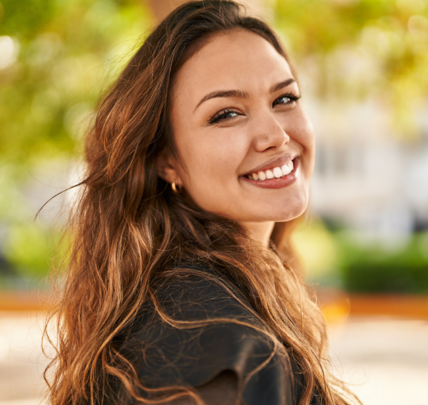 Young brunette woman smiling after getting tooth-colored fillings in Cocoa Beach