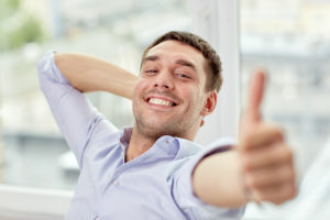 man smiling with a thumbs up